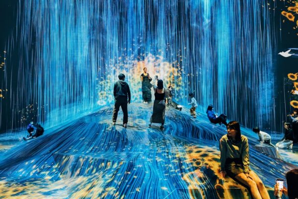 A group of people standing in a blue room