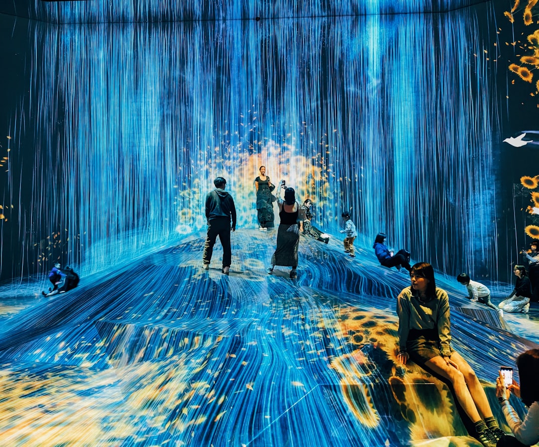 A group of people standing in a blue room