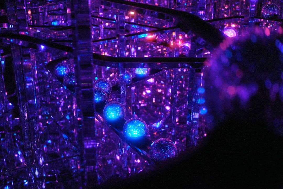 Abstract glowing spheres in a dark, reflective space.