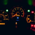 black and yellow analog speedometer