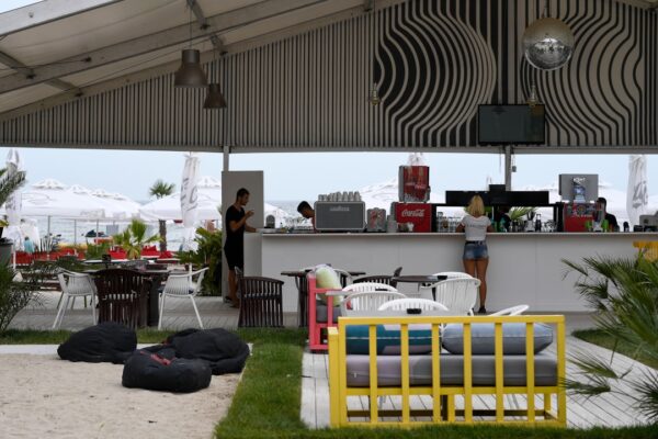 Beachside bar with seating and a disco ball