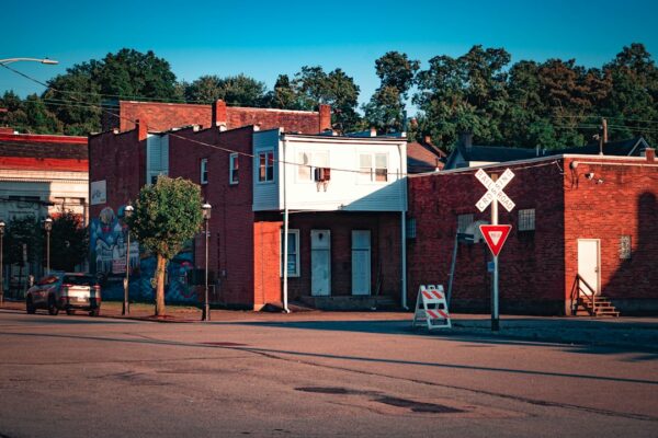 a red brick building with a street sign in front of it