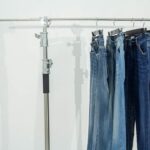 a pair of jeans hanging on a clothes rack